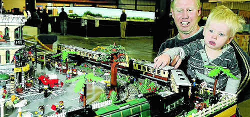Daniel Schick recoils as two-year-old son Fletcher makes a grab for a Lego train at the Toowoomba Showgrounds on Saturday.